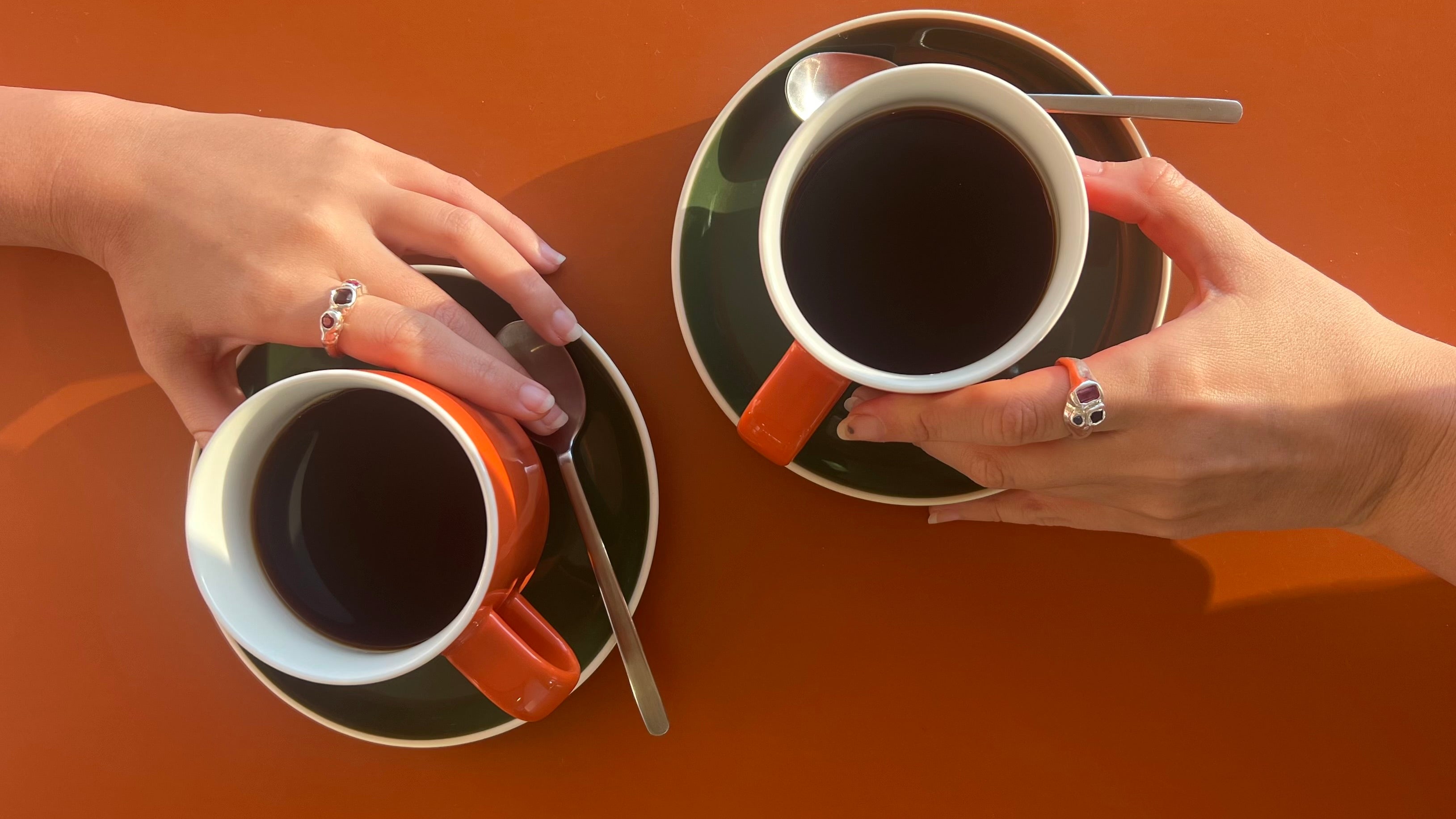 Daisy. Collectives rings and womens hands holding coffee